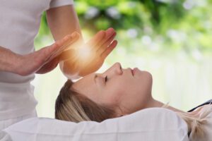 Woman having reiki healing treatment, alternative medicine, holistic care concept.