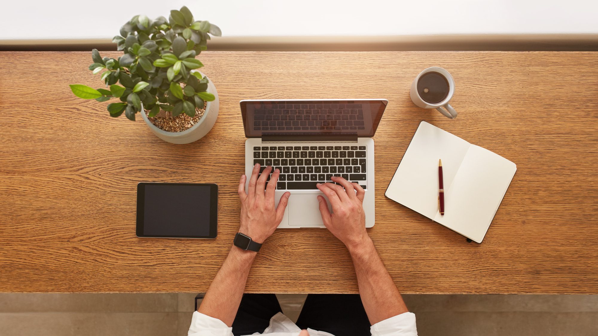 Directly Above View Of Human Hands Typing On Laptop
