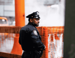 Photo of police officer standing by Martin Jernberg via Unsplash