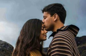 A couple kissing on forehead by Victoria Roman on Unsplash