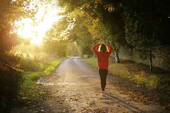 Woman walking on path Photo by Emma Simpson on Unsplash