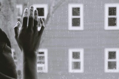 hand on a rainy window Photo by Kristina Tripkovic on Unsplash