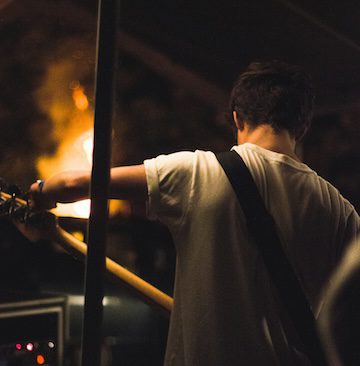 guitar and fire Photo by James Fitzgerald on Unsplash