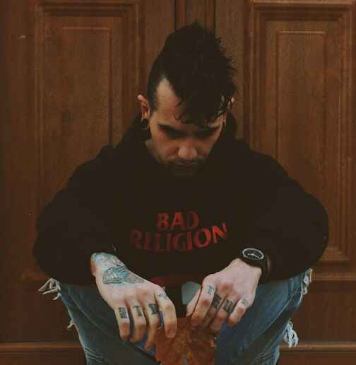 man sitting Photo by Panos Sakalakis on Unsplash