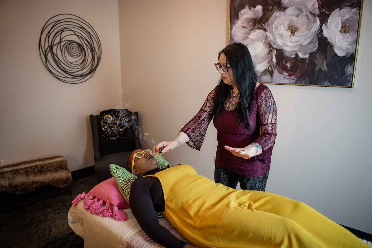 A woman performing reiki on a person